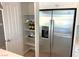 Kitchen pantry and stainless steel refrigerator at 6507 Dove Point Pl, Las Vegas, NV 89130