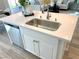 Kitchen island features a stainless steel sink, dishwasher, and plenty of storage space at 6507 Dove Point Pl, Las Vegas, NV 89130