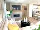 Living room view with open floorplan featuring the kitchen, island with bar stools, fireplace, and white cabinets at 6507 Dove Point Pl, Las Vegas, NV 89130