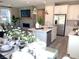 Inviting open-concept living space with tile floors, fireplace, modern fixtures, and white cabinets at 6507 Dove Point Pl, Las Vegas, NV 89130