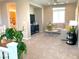 Bright living room area with comfortable seating, a ceiling fan, and natural light at 6507 Dove Point Pl, Las Vegas, NV 89130