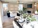 Open-concept living and dining area filled with natural light and featuring modern décor and tile flooring at 6507 Dove Point Pl, Las Vegas, NV 89130