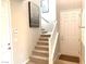 Well-lit stairway with carpeted steps, white railings, and easy access to the upper floors at 6507 Dove Point Pl, Las Vegas, NV 89130