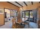Dining area with chandelier lighting, wooden table and chairs, and backyard views at 6998 Alamitos Cir, Las Vegas, NV 89120