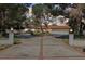 Expansive home featuring a circular driveway, mature trees, and three-car garage at 6998 Alamitos Cir, Las Vegas, NV 89120
