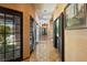 Tiled hallway with decorative lighting and multiple doorways at 6998 Alamitos Cir, Las Vegas, NV 89120