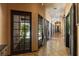 Long hallway features large windows and tile flooring, bringing natural light at 6998 Alamitos Cir, Las Vegas, NV 89120