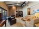 Spacious living room with vaulted ceilings, brick wall and multiple seating options at 6998 Alamitos Cir, Las Vegas, NV 89120