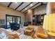 Vaulted ceiling living room with brick accent wall, fireplace, and sliding glass door at 6998 Alamitos Cir, Las Vegas, NV 89120