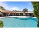 Large pool surrounded by patio, and a glimpse of the backyard at 6998 Alamitos Cir, Las Vegas, NV 89120
