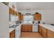 Bright kitchen with white appliances, light wood cabinets, and tile flooring at 735 Sea Pines Ln, Las Vegas, NV 89107