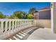 Sunny balcony with decorative white railing and views of neighborhood landscaping at 8200 Horseshoe Bend Ln, Las Vegas, NV 89113