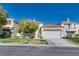 Charming two-story stucco home with a red tile roof, lush green lawn, and a two-car garage at 8200 Horseshoe Bend Ln, Las Vegas, NV 89113