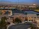 Scenic aerial view of a residential neighborhood featuring well-maintained homes, and a school with mountain views at 827 Happy Sparrow Ave, Henderson, NV 89052