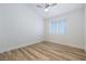 Bedroom featuring wood-look flooring, modern ceiling fan, and large window with blinds at 827 Happy Sparrow Ave, Henderson, NV 89052
