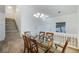 Dining room featuring a glass-top table, wood chairs, and high ceilings at 827 Happy Sparrow Ave, Henderson, NV 89052