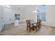 Open dining area with tile floors, vaulted ceilings, and a modern light fixture above the glass table at 827 Happy Sparrow Ave, Henderson, NV 89052