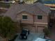 Aerial view showcasing the house with a three-car garage and well-maintained grounds at 827 Happy Sparrow Ave, Henderson, NV 89052