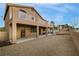 Exterior view of a two-story home featuring a backyard and multiple balconies at 827 Happy Sparrow Ave, Henderson, NV 89052