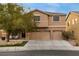 Inviting two-story home with a three-car garage, cozy porch, and well-maintained landscaping at 827 Happy Sparrow Ave, Henderson, NV 89052