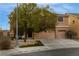 Charming two-story home with a three-car garage, mature tree, and covered porch at 827 Happy Sparrow Ave, Henderson, NV 89052