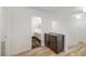Hallway with wooden floors, dark cabinet and view of luxurious bathroom at 827 Happy Sparrow Ave, Henderson, NV 89052