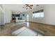 Bright living area with tile floors, white walls, ceiling fan, and adjacent kitchen at 827 Happy Sparrow Ave, Henderson, NV 89052