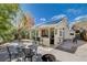 Spacious backyard features outdoor bar area, seating, and mature landscaping with bright blue skies at 8988 Dusseldorf Way, Las Vegas, NV 89147
