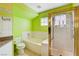 Bright bathroom with a tub, separate shower with glass door, and tiled floors at 8988 Dusseldorf Way, Las Vegas, NV 89147