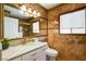 Elegant bathroom featuring a marble vanity, decorative mirror, and tiled walls at 8988 Dusseldorf Way, Las Vegas, NV 89147