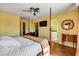 Bright bedroom featuring a four-poster bed, ceiling fan, and ensuite bathroom at 8988 Dusseldorf Way, Las Vegas, NV 89147