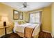 A well-lit bedroom with a double bed, mirrors, and a ceiling fan at 8988 Dusseldorf Way, Las Vegas, NV 89147