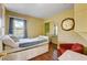 A bright bedroom with a large window and hardwood floors at 8988 Dusseldorf Way, Las Vegas, NV 89147