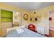 A well-lit bedroom with a red chair, shelves, and a mirror closet door at 8988 Dusseldorf Way, Las Vegas, NV 89147