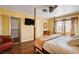 Cozy bedroom featuring wood floors, large windows, and a comfortable four-poster bed at 8988 Dusseldorf Way, Las Vegas, NV 89147