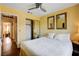 A furnished bedroom with a ceiling fan, hardwood floors, and natural light at 8988 Dusseldorf Way, Las Vegas, NV 89147