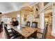 Open-concept dining room with hardwood floors, a view of the living room, and a formal dining set at 8988 Dusseldorf Way, Las Vegas, NV 89147