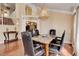A dining room with wood floors, wainscoting, a decorative chandelier, and formal dining furniture at 8988 Dusseldorf Way, Las Vegas, NV 89147