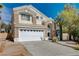 Charming two-story home featuring a large front yard, two-car garage, and stone and stucco facade at 8988 Dusseldorf Way, Las Vegas, NV 89147
