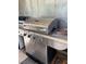 Stainless steel grill in outdoor area with wood storage underneath at 8988 Dusseldorf Way, Las Vegas, NV 89147