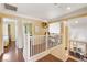 Upstairs hallway featuring hardwood floors and views of the dining room at 8988 Dusseldorf Way, Las Vegas, NV 89147