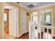 Upstairs hallway with hardwood floors offering access to bedrooms and a bathroom at 8988 Dusseldorf Way, Las Vegas, NV 89147