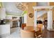 Eat in kitchen with stainless appliances, white cabinets, and an adjoining living space at 8988 Dusseldorf Way, Las Vegas, NV 89147