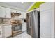 Modern kitchen features stainless steel appliances and ample storage at 8988 Dusseldorf Way, Las Vegas, NV 89147
