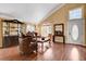 A living room with hardwood floors, ornate furniture, and a front door with an oval window at 8988 Dusseldorf Way, Las Vegas, NV 89147