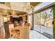 Cozy living room featuring a fireplace, natural lighting, and access to the patio at 8988 Dusseldorf Way, Las Vegas, NV 89147