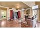 Cozy living room featuring a fireplace, large-screen television, and a view into the laundry area at 8988 Dusseldorf Way, Las Vegas, NV 89147