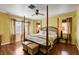 Main bedroom with hardwood floors and large windows, showcasing natural light and airy ambiance at 8988 Dusseldorf Way, Las Vegas, NV 89147