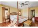Main bedroom showcasing a four-poster bed, hardwood floors and lots of natural light at 8988 Dusseldorf Way, Las Vegas, NV 89147