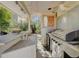 A covered outdoor kitchen with granite countertops and a stainless steel gas grill at 8988 Dusseldorf Way, Las Vegas, NV 89147